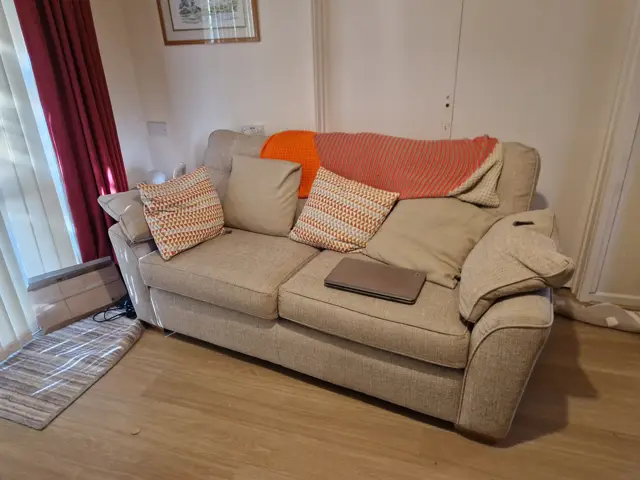 Living room before clearance — sofa, cushions and furnishings