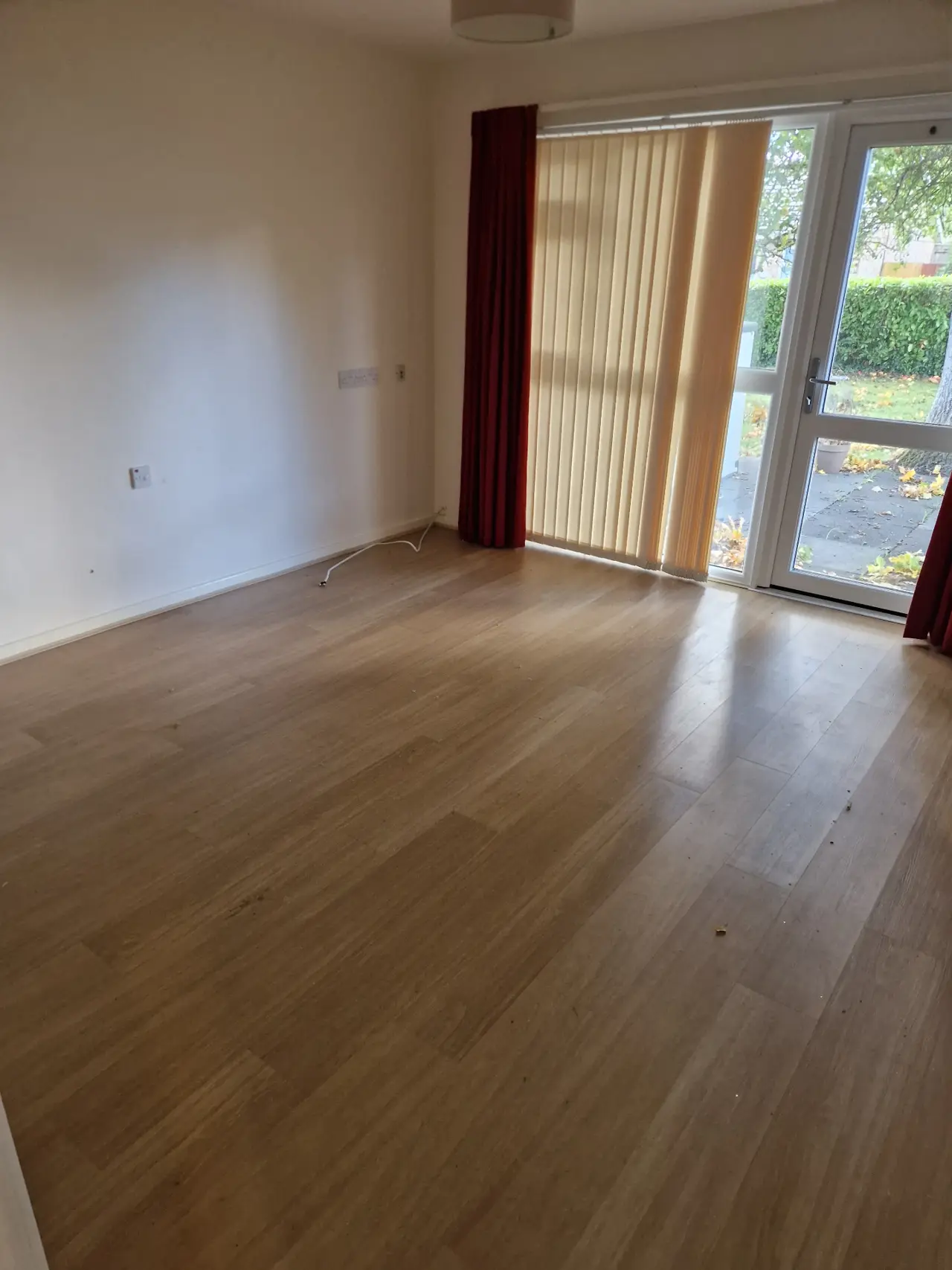 Living room after clearance — empty, swept floor